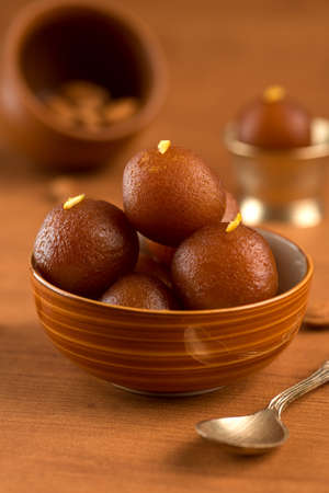 Gulab Jamun in bowl and copper antique bowl with spoon. Indian Dessert or Sweet Dish.の写真素材