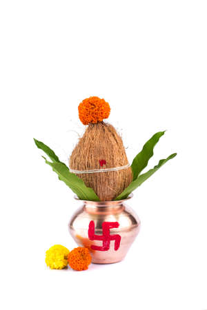 Copper Kalash with coconut and mango leaf with floral decoration on a white background. Essential in Hindu Puja.の写真素材