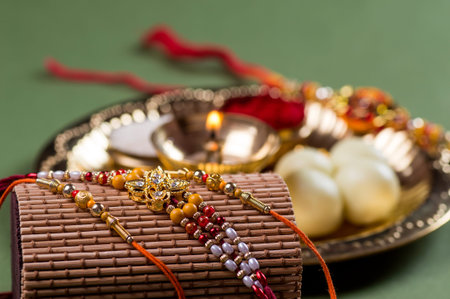 Indian Festival: Raksha Bandhan or Rakhi background with an elegant Rakhi and diya