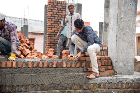 AMRAVATI, MAHARASHTRA - AUGUST 28, 2018: Construction workers working at a development site.のeditorial素材