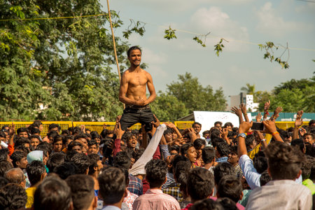 AMRAVATI, MAHARASHTRA, INDIA - 8 SEPTEMBER 2018: Crowd of young People enjoying and dancing in the "Govinda" at Dahi Handi festival to celebrate God Krishna's Birth.のeditorial素材