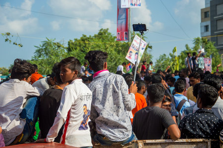 AMRAVATI, MAHARASHTRA, INDIA - 8 SEPTEMBER 2018: Crowd of young People enjoying and dancing in the...