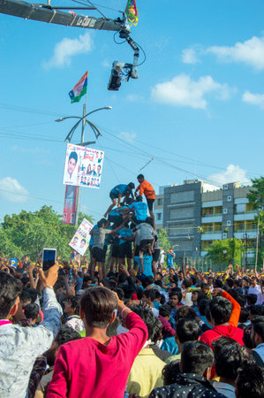 AMRAVATI, MAHARASHTRA, INDIA - 8 SEPTEMBER 2018: Crowd of young People enjoying and dancing in the...