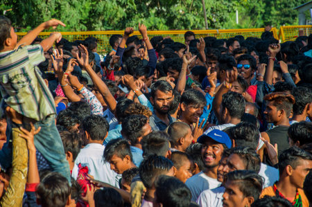 AMRAVATI, MAHARASHTRA, INDIA - 8 SEPTEMBER 2018: Crowd of young People enjoying and dancing in the...