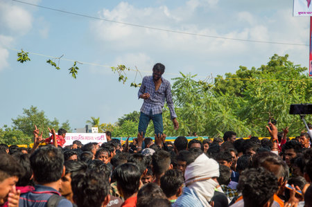 AMRAVATI, MAHARASHTRA, INDIA - 8 SEPTEMBER 2018: Crowd of young People enjoying and dancing in the...