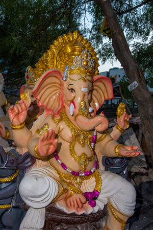 AMRAVATI, MAHARASHTRA - SEPTEMBER 8, 2018: Artist making a statue and gives finishing touches on an...