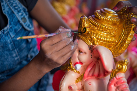 AMRAVATI, MAHARASHTRA - AUGUST 25, 2018: Artist making a statue and gives finishing touches on an...
