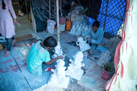 AMRAVATI, MAHARASHTRA - SEPTEMBER 8, 2018: Artist making a statue and gives finishing touches on an...