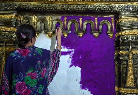AMRAVATI, MAHARASHTRA - SEPTEMBER 8, 2018: Artist making a statue and gives finishing touches on an idol of the Hindu god Lord Ganesha at an artist's workshop for Ganesha festival.のeditorial素材