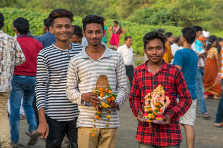 AMRAVATI, MAHARASHTRA, INDIA - 23 SEPTEMBER 2018: Unidentified faithful people carrying Hindu God Ganesha before immersion near water bodies during Ganesh festival. Annual festival.のeditorial素材
