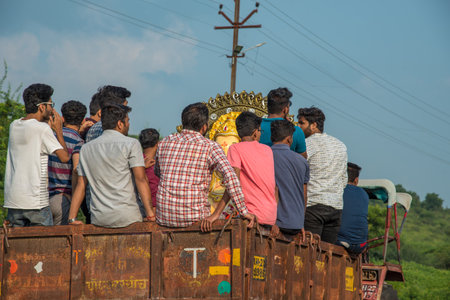 AMRAVATI, MAHARASHTRA, INDIA - 23 SEPTEMBER 2018: Unidentified faithful people carrying Hindu God Ganesha before immersion near water bodies during Ganesh festival. Annual festival.のeditorial素材