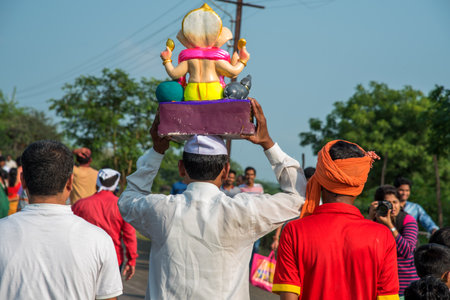 AMRAVATI, MAHARASHTRA, INDIA - 23 SEPTEMBER 2018: Unidentified faithful people carrying Hindu God Ganesha before immersion near water bodies during Ganesh festival. Annual festival.のeditorial素材