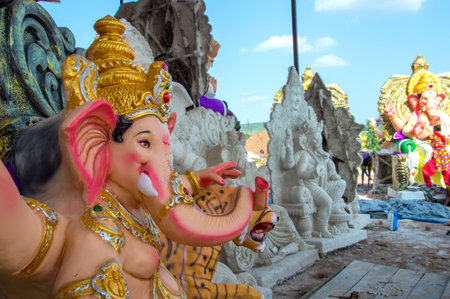 AMRAVATI, MAHARASHTRA - SEPTEMBER 8, 2018: Artist making a statue and gives finishing touches on an idol of the Hindu god Lord Ganesha at an artist's workshop for Ganesha festival.のeditorial素材