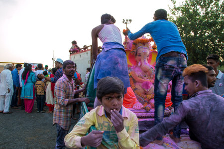 AMRAVATI, MAHARASHTRA, INDIA - 23 SEPTEMBER 2018: Unidentified faithful people carrying Hindu God...