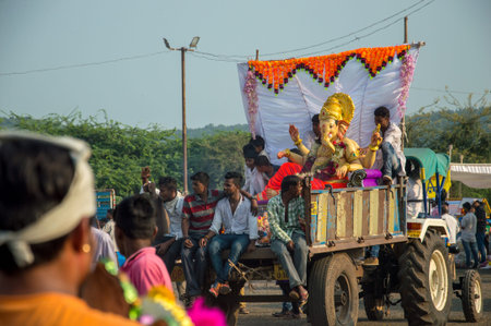 AMRAVATI, MAHARASHTRA, INDIA - 23 SEPTEMBER 2018: Unidentified faithful people carrying Hindu God...