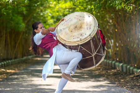 AMRAVATI, MAHARASHTRA, INDIA - SEPTEMBER 24: Unidentified group of young people celebrating Festival in park by playing drums with music.のeditorial素材