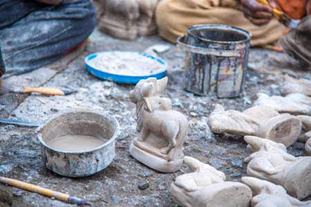 AMRAVATI, MAHARASHTRA - AUGUST 24, 2018: Artist gives finishing touches on statue of Bull at an artist's workshop for Bail (Bull) Pola Festival.のeditorial素材