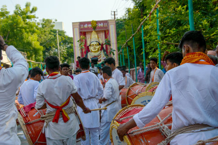 AMRAVATI, MAHARASHTRA, INDIA - 27 SEPTEMBER 2018: Crowd of unidentified people beating traditional...