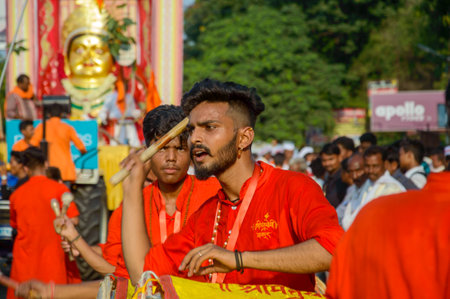 AMRAVATI, MAHARASHTRA, INDIA - 27 SEPTEMBER 2018: Crowd of unidentified people beating traditional drums in front of idol of the Goddess Ekvira during Ganesh Chaturthi festival.のeditorial素材