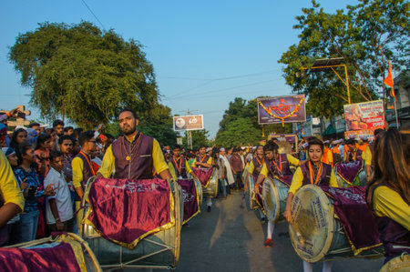 AMRAVATI, MAHARASHTRA, INDIA - 27 SEPTEMBER 2018: Crowd of unidentified people carrying Hindu God Ganesha for immersion with drums and music at water bodies during Ganesha festival. Annual festival.のeditorial素材