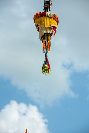 Dahi Handi background on Gokul Ashtami festival with hanging pot filling with curd with flower...