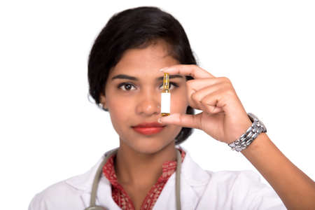 Female Doctor showing the tube of medicine on white backgroundの写真素材