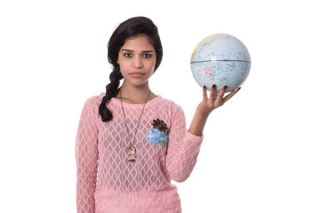 Beautiful Girl holding a world globe isolated on a white backgroundの写真素材