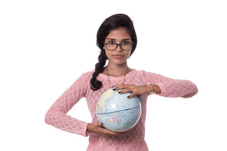 Beautiful Girl holding a world globe isolated on a white backgroundの写真素材