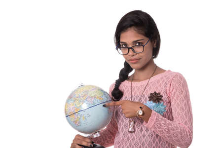 Beautiful Girl holding a world globe isolated on a white backgroundの写真素材