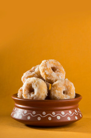 Indian Traditional Sweet Food Balushahi on a yellow background