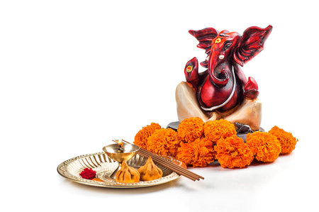 Hindu God Ganesha. Statue of Lord Ganesha. Worship (Pooja) arrangement on white background.