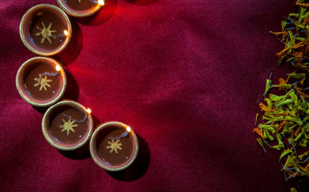 Clay diya lamps lit during Diwali Celebration. Greetings Card Design Indian Hindu Light Festival called Diwaliの写真素材