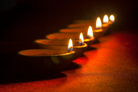 Clay diya lamps lit during Diwali Celebration. Greetings Card Design Indian Hindu Light Festival...