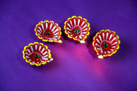 Clay diya lamps lit during Diwali Celebration. Greetings Card Design Indian Hindu Light Festival called Diwaliの写真素材