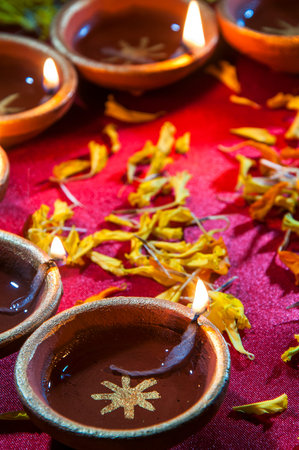 Clay diya lamps lit during Diwali Celebration. Greetings Card Design Indian Hindu Light Festival...
