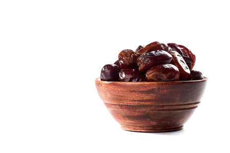 Dates in bowl on a white background. dried dates fruit.の写真素材