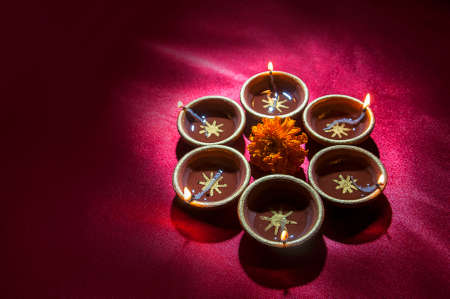 Clay diya lamps lit during Diwali Celebration. Greetings Card Design Indian Hindu Light Festival called Diwaliの写真素材