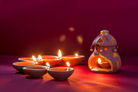 Clay diya lamps lit during Diwali Celebration. Greetings Card Design Indian Hindu Light Festival...