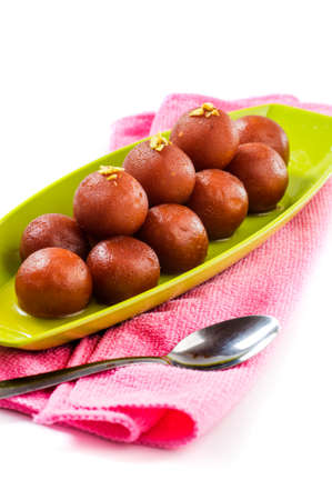 Indian Dessert Gulab Jamun in plate isolated on white backgroundの写真素材