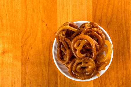 Jalebi Indian sweet dish on a wooden backgroundの写真素材