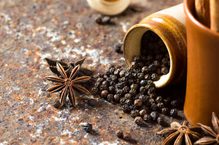 Spices and herbs. Food and cuisine ingredients. Cinnamon sticks, anise stars, black peppercorns on textured backgroundの写真素材