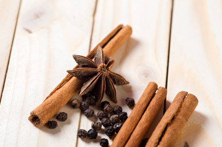 Spices and herbs. Food and cuisine ingredients. Cinnamon sticks, anise stars and black peppercorns on a wooden background.の写真素材