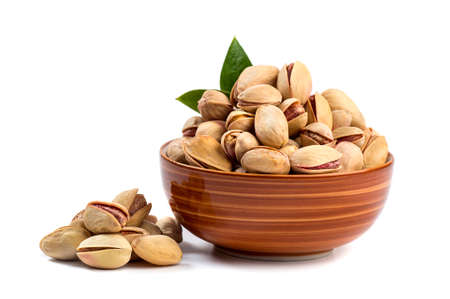 Pistachio in bowl on white backgroundの写真素材
