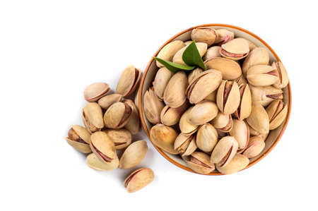 Pistachio in bowl on white backgroundの写真素材