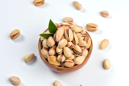 Pistachio in bowl on white backgroundの写真素材
