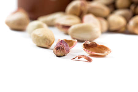 Pistachio and Cashew Nuts in clay pots on white backgroundの写真素材