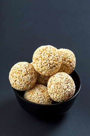 Amaranth or Rajgira laddu, Cholai ke laddo in black Bowl on black backgroundの写真素材