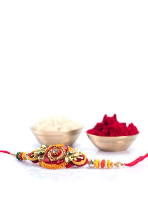 Indian festival: Raksha Bandhan background with an elegant Rakhi on a white background. A traditional Indian wrist band which is a symbol of love between Brothers and Sistersの写真素材