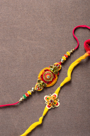 Raksha Bandhan background with an elegant Rakhi. A traditional Indian wrist band