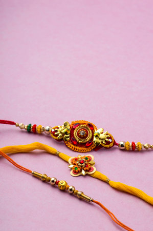 Raksha Bandhan background with an elegant Rakhi. A traditional Indian wrist band which is a symbol...